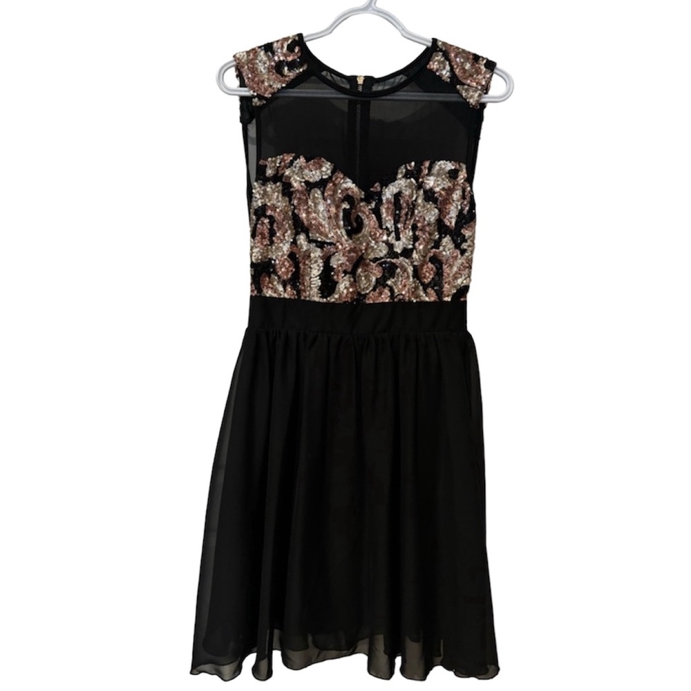 Party dress with mesh top and sequins. Black fits a Xs to small